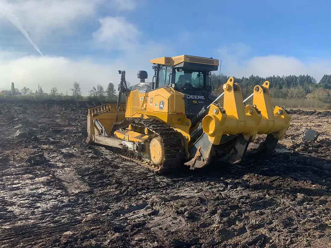 Dozer with ripper clearing ground for an outdoor horse arena